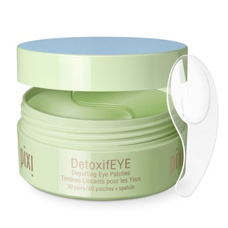 open green tub of pixi detoxifye eye patches with clear applicator on a white background
